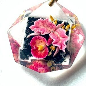 Vintage reverse carved dimensional lucite detailed orchid on black pendant